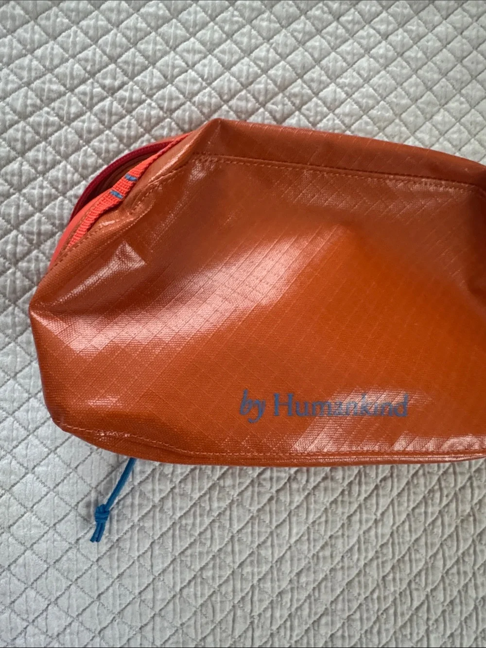 Humankind Orange Zip Travel Pouch with Blue Logo